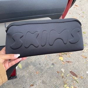 SKIMS neoprene pouch in soot Black bag clutch for your shapewear